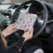 Blue Badge Wallet in Mulberry Rose Fabric is held in two hands against the steering wheel of a vehicle.