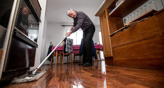 elder mopping the floor
