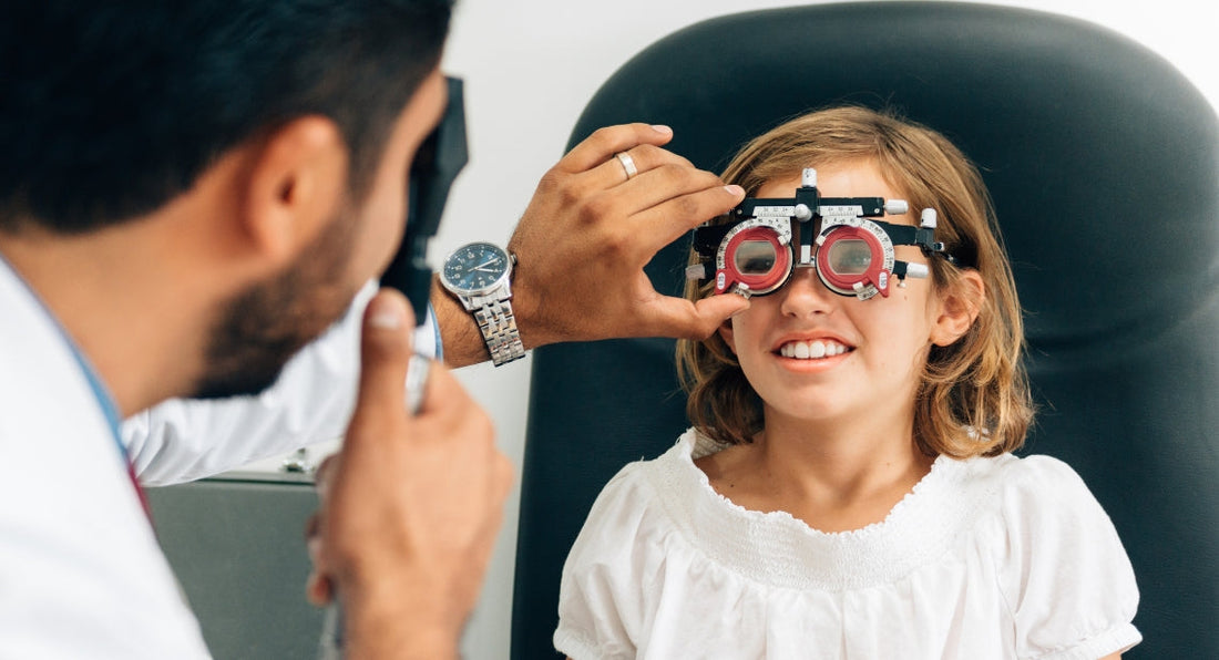 Young girl wearing a trial frame during an eye exam.