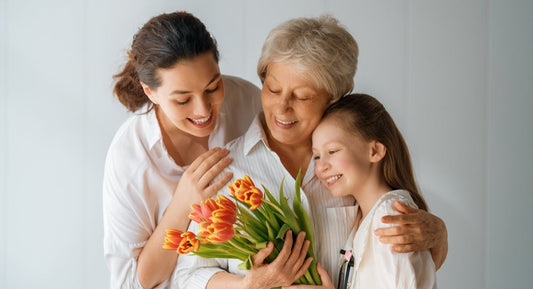 elder is holding a young girl, young woman holding both of them
