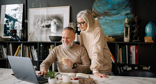 elder couple watching laptop