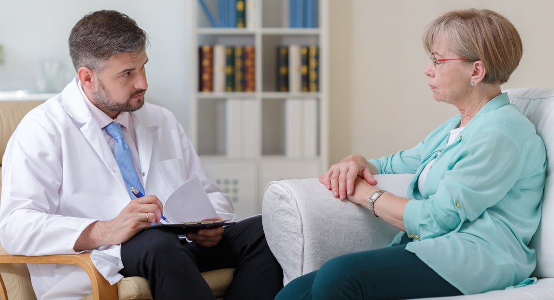 a consultation between a male doctor and an elderly female patient 
