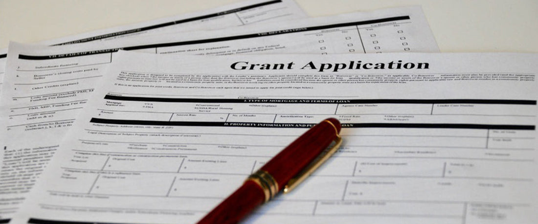 Grants application on the table with a pen