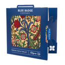 Disabled Blue Badge Wallet in William Morris Golden Lily fabric is packed in blue badge company recyclable packaging. The Blue Badge Co label sits outside the card box through a side gap. Packaging reads "Blue Badge Company" at the top and "Parking Display Wallet, Hologram Safe" at the bottom.