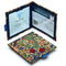 Two Disabled Blue Badge Wallets in William Morris Golden Lily fabric are pictured. One stands open showing clock display on left behind plastic window, with room to adjust time dial. On the right is a card insert showing place for permit with a hologram safe design. Second, closed wallet lays in front of the open wallet to display fabric. The William Morris Golden Lily fabric is a classic botanical print depicting leaves and flowers in red, green, gold and blue, on a rich cream background.
