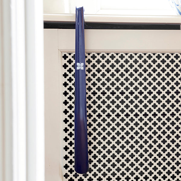 Long Handled Shoe Horn in Navy hung on shelf at home