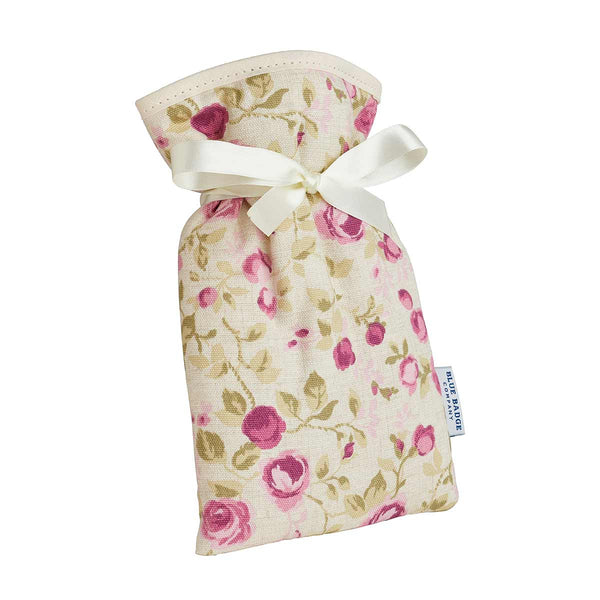 Mini Hot Water Bottle in Mulberry Rose with white satin ribbon and blue badge company label showing