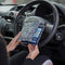 The Blue Badge Wallet is held slightly open, in two hands, against a steering wheel.