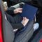 The Blue Badge Wallet in Navy Drill fabric is held in two hands, to the side of a figure seated in the front seat of a vehicle.
