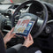 The Blue Badge Wallet is held slightly open, in two hands, against a steering wheel.