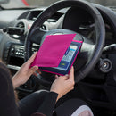 The Blue Badge Wallet is held slightly open, in two hands, against a steering wheel.