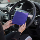 Blue Badge wallet in Purple Drill fabric is held in two hands against the steering wheel of a vehicle.